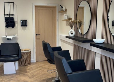 Modern salon interior at Becky With The Good Hair - West End, Southampton, GB, featuring stylish black chairs.