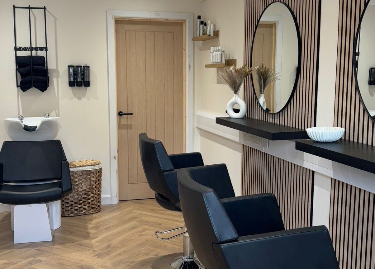 Modern salon interior at Becky With The Good Hair - West End, Southampton, GB, featuring stylish black chairs.
