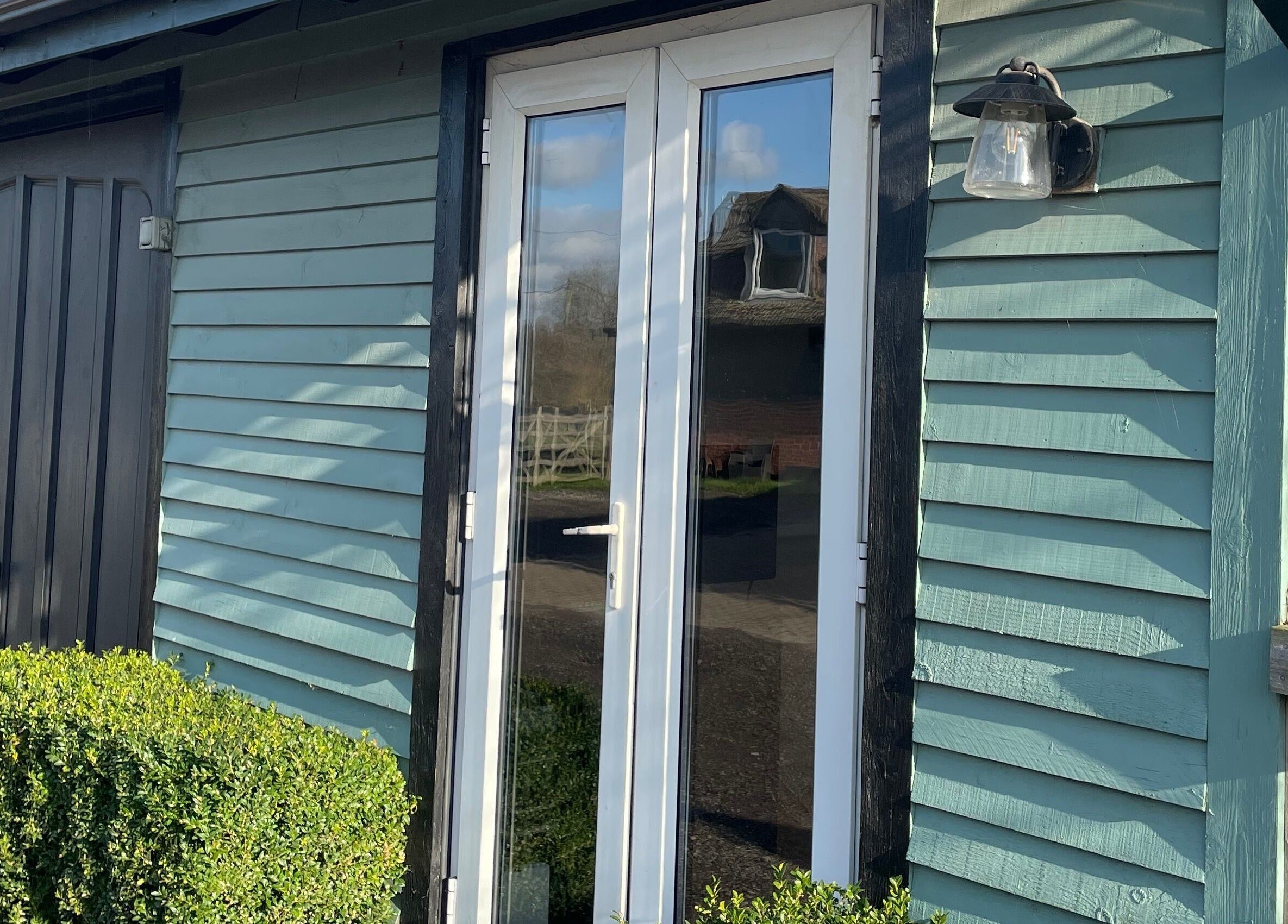 Entrance of Becky With The Good Hair - West End, Southampton, GB; stylish wooden facade with glass doors.