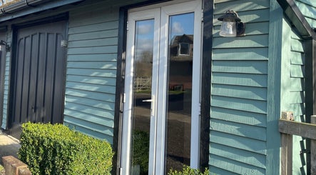 Entrance of Becky With The Good Hair - West End, Southampton, GB; stylish wooden facade with glass doors.