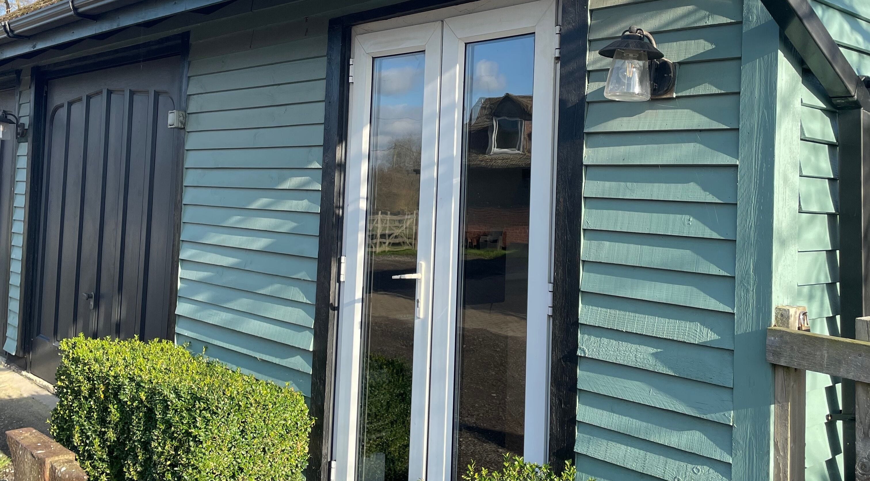 Entrance of Becky With The Good Hair - West End, Southampton, GB; stylish wooden facade with glass doors.