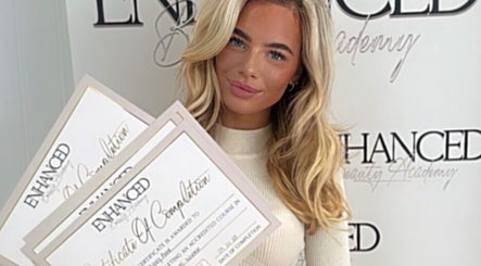 Graduate displaying certificates at Dolled By Moll, Chislehurst, England, GB.