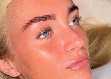 Close-up of a woman's glowing skin and styled brows at Dolled By Moll, Chislehurst, England, GB.