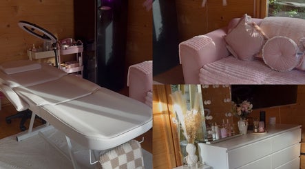 Relaxing interior at Dolled By Molls, Chislehurst, England, GB featuring a treatment bed and cozy pink sofa.