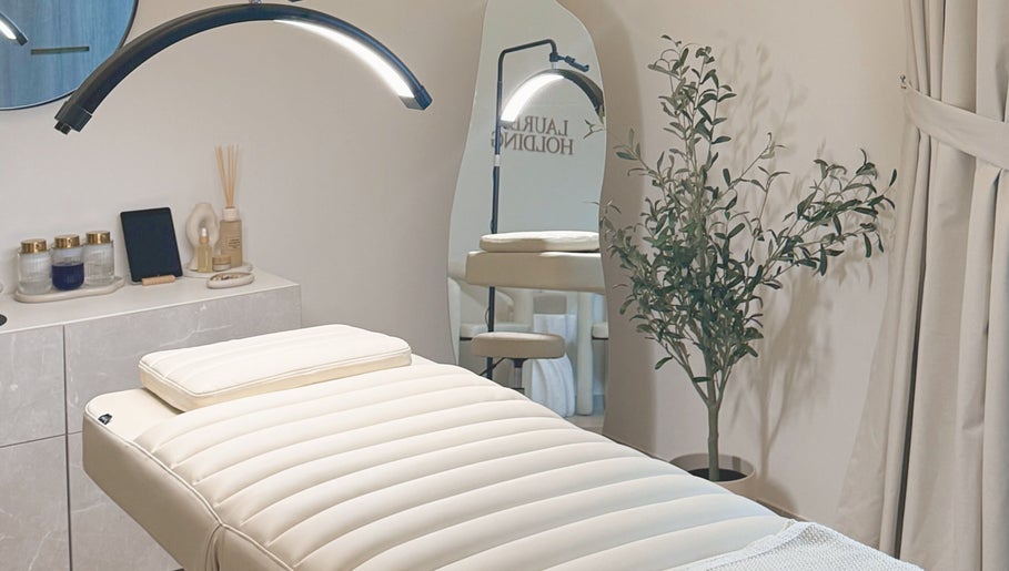 Tranquil treatment room at Lauren Brows and Beauty, Dubai, Dubai, AE, featuring a plush bed and elegant decor.