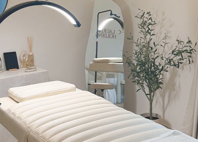 Tranquil treatment room at Lauren Brows and Beauty, Dubai, Dubai, AE, featuring a plush bed and elegant decor.