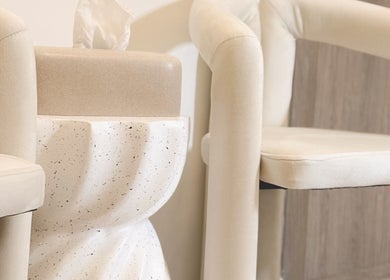 Cozy seating area detail at Lauren Brows and Beauty, Dubai, Dubai, AE, with cream chairs and modern decor.