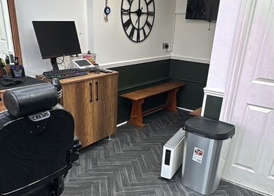 Interior of Gents & Co. Barbershop in Clacton-on-sea, England, featuring a stylish barber chair and wooden decor.