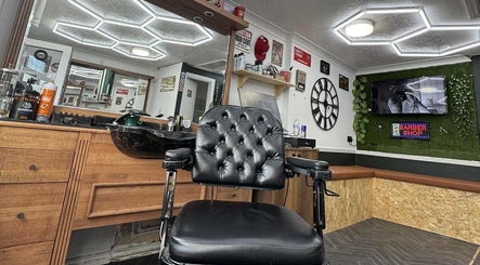 Stylish interior of Gents & Co. Barbershop in Clacton-on-sea, England, with leather chair and modern design.