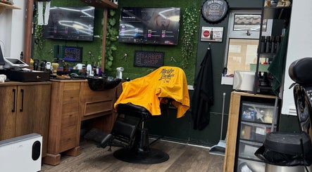 Inside Gents & Co. Barbershop in Clacton-on-sea, England: stylish chair, rustic wood decor, and vibrant atmosphere.