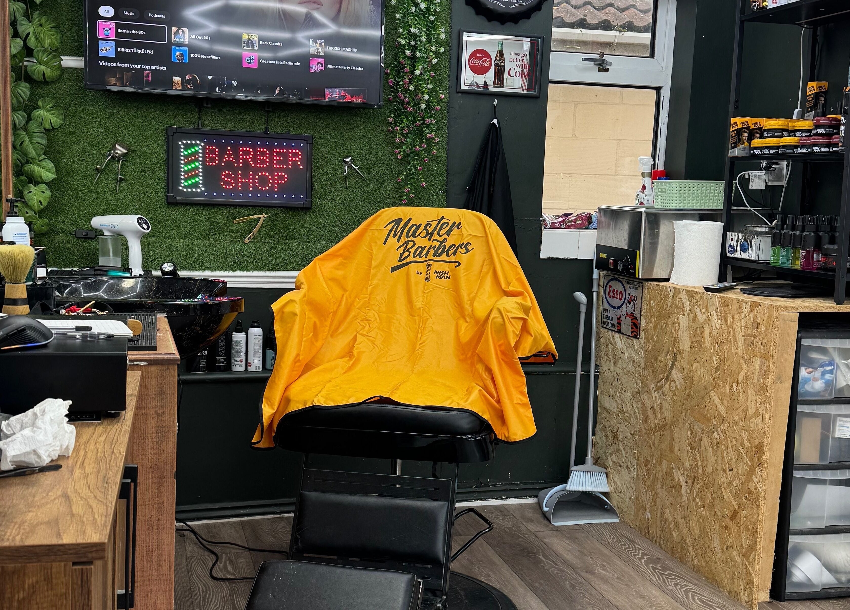 Stylish interior of Gents & Co. Barbershop in Clacton-on-sea, England, GB with modern barber chair.