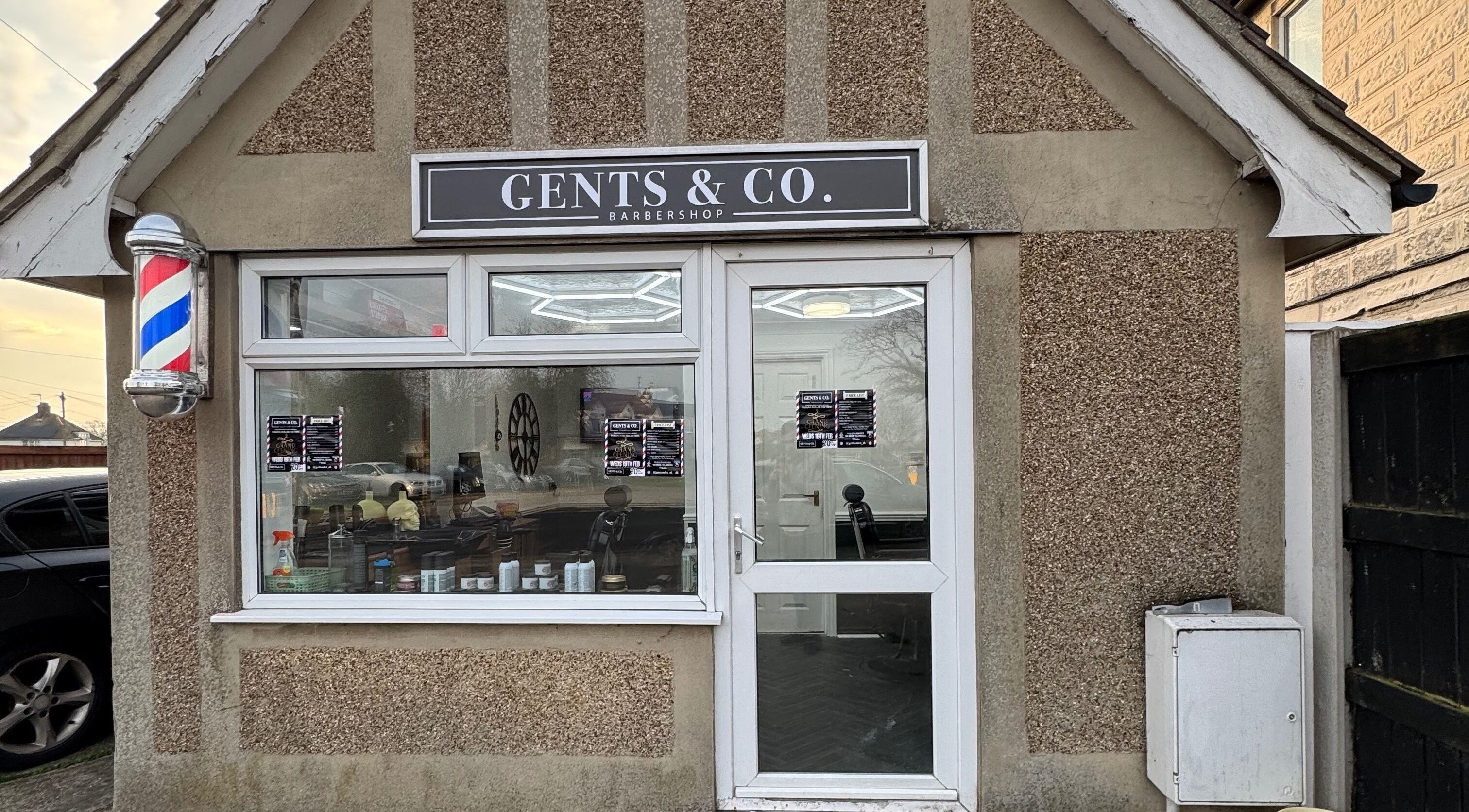 Front view of Gents & Co. Barbershop in Clacton-on-sea, England, GB with classic barber pole.