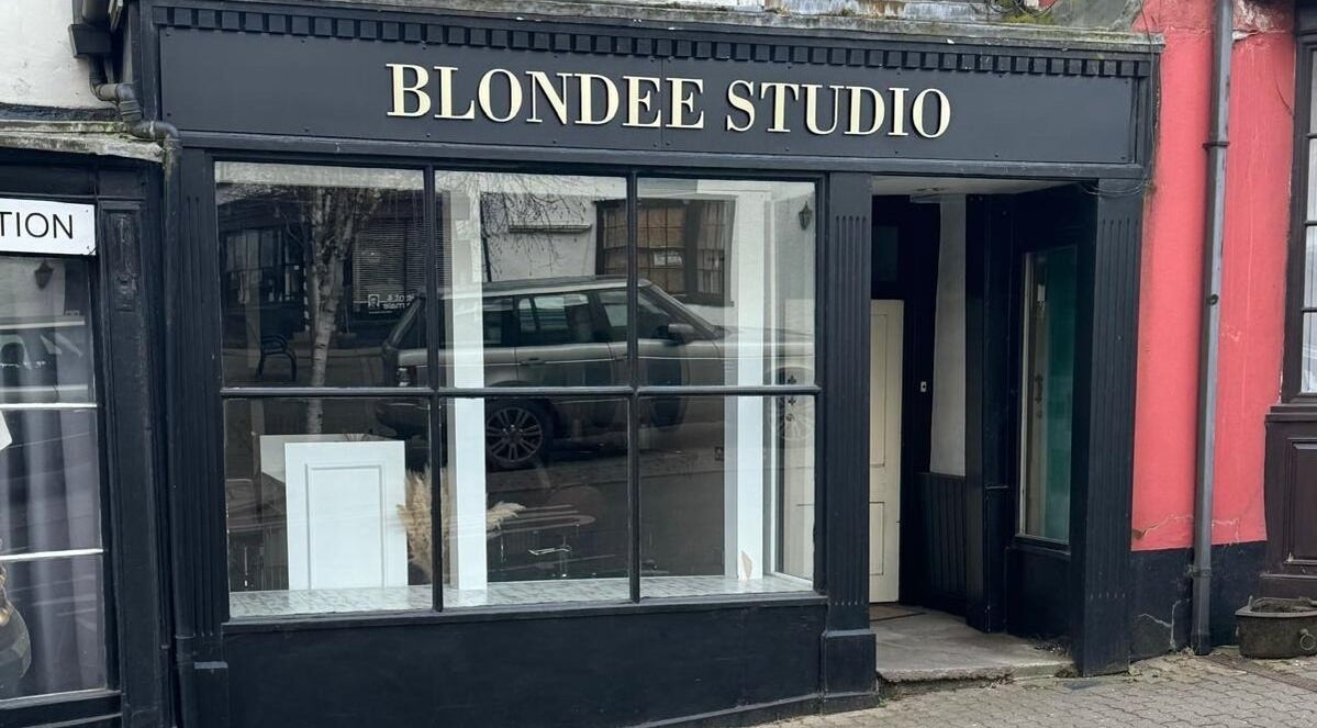 Exterior of Ben Nicholson Hair in Bromyard, England, GB with stylish black storefront and large windows.
