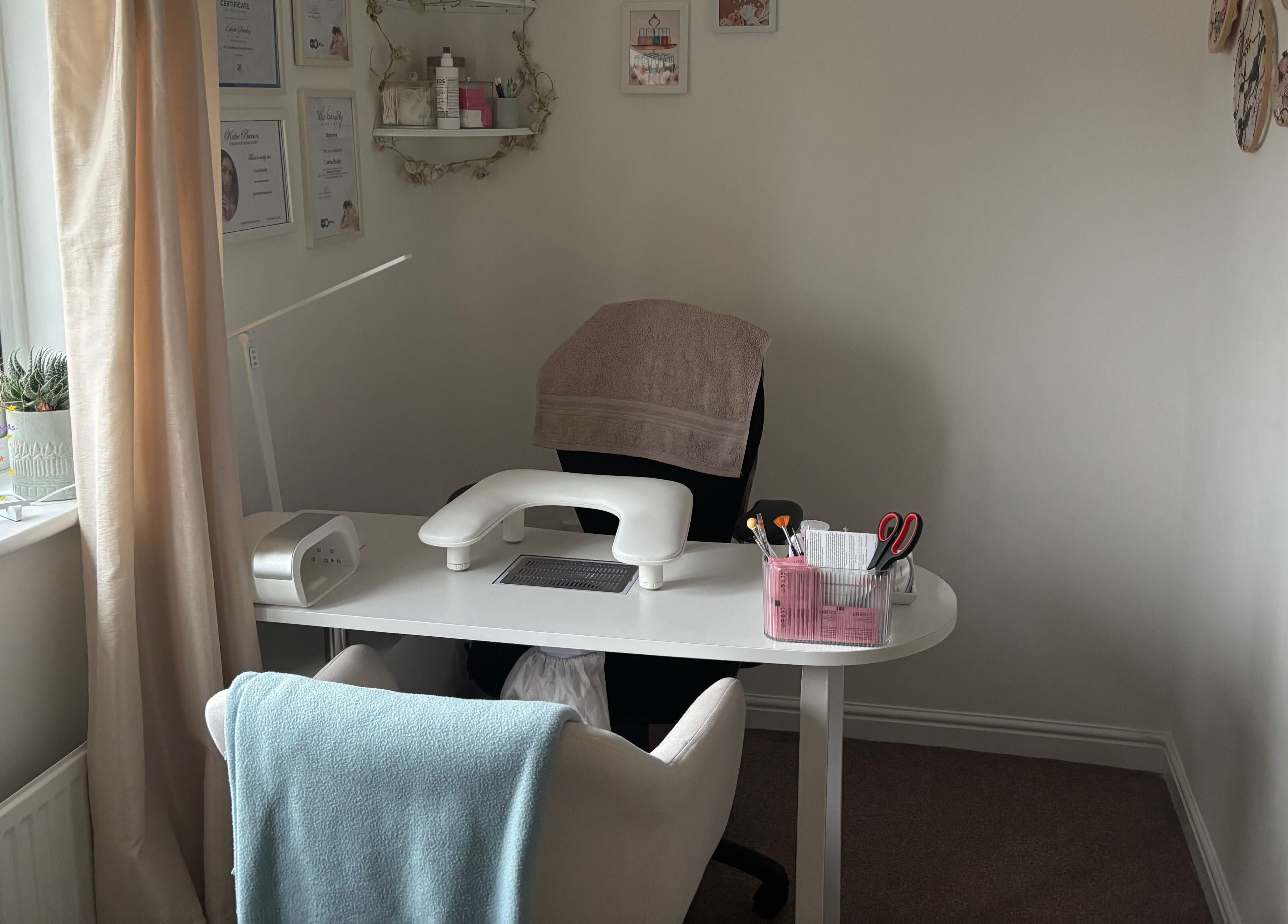 The Nail Room in Witchford, England, GB, featuring a cozy manicure station with soft lighting and tools.