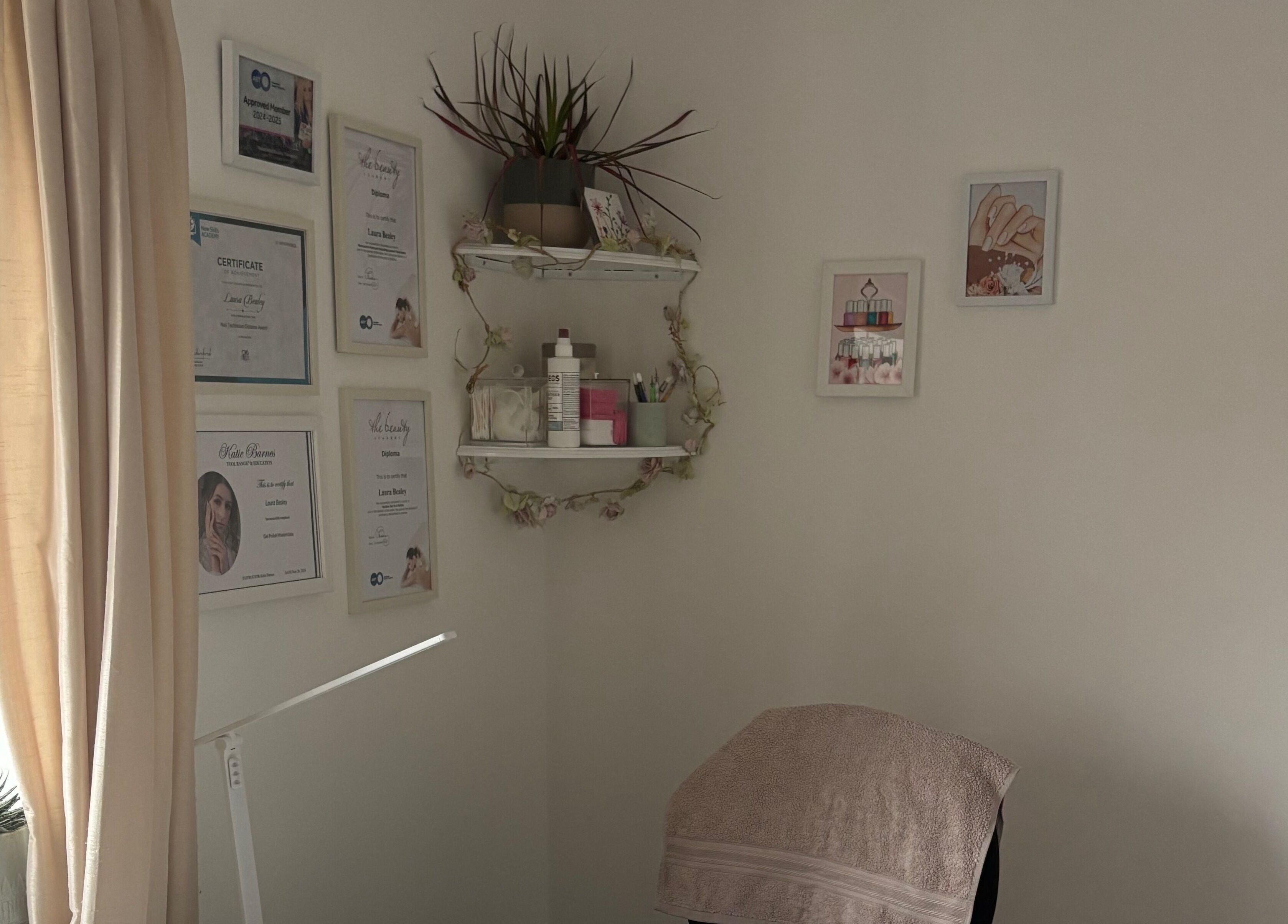 The Nail Room in Witchford, England, GB features a cozy corner with certificates and decorative shelves.
