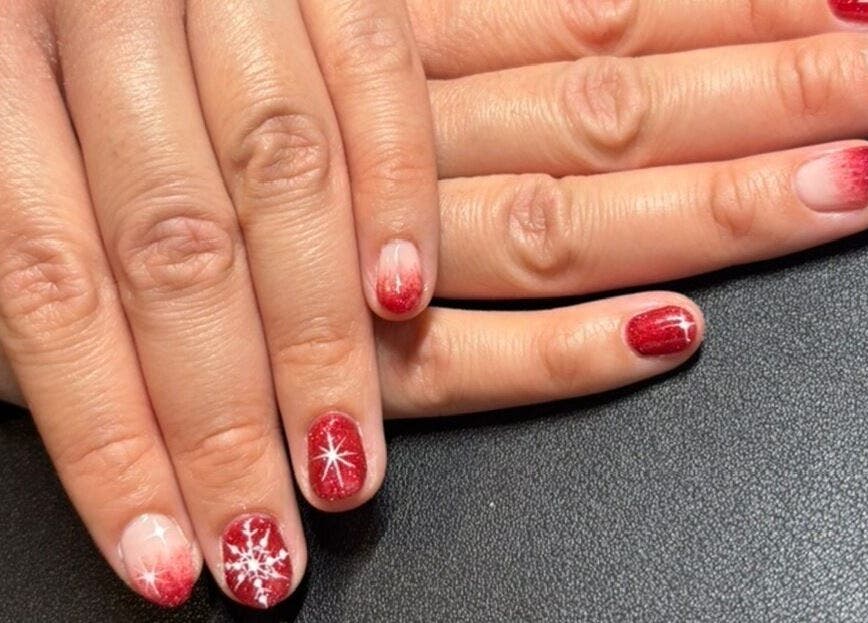 Red and glitter nail art at The Nail Room, Witchford, England, GB, featuring snowflake designs.