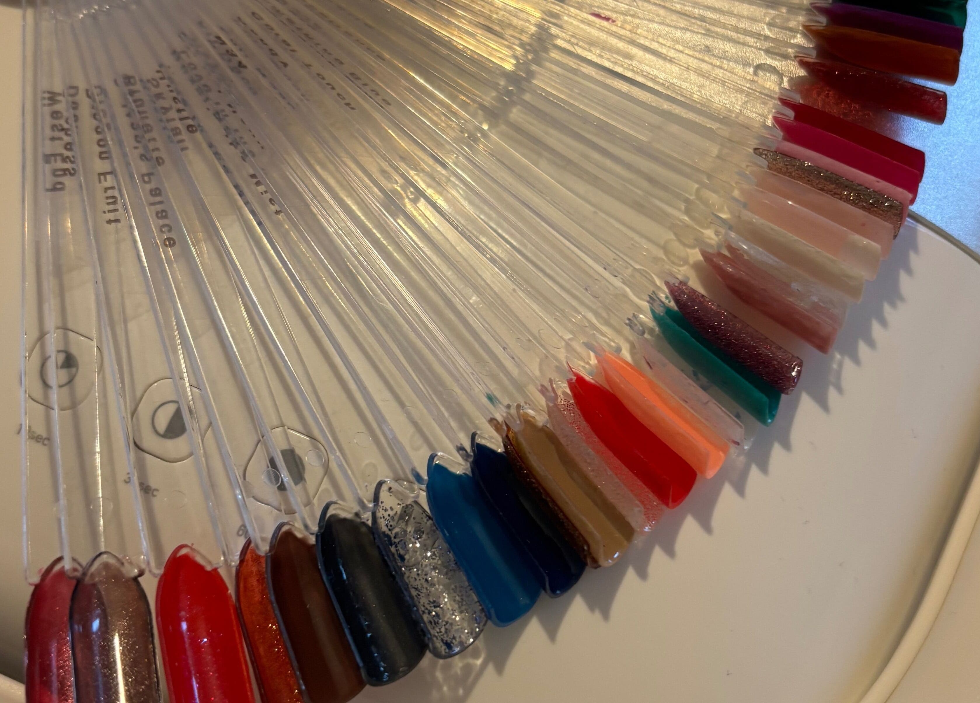 Colorful nail polish swatches at The Nail Room, Witchford, England, GB, showcasing diverse manicure options.