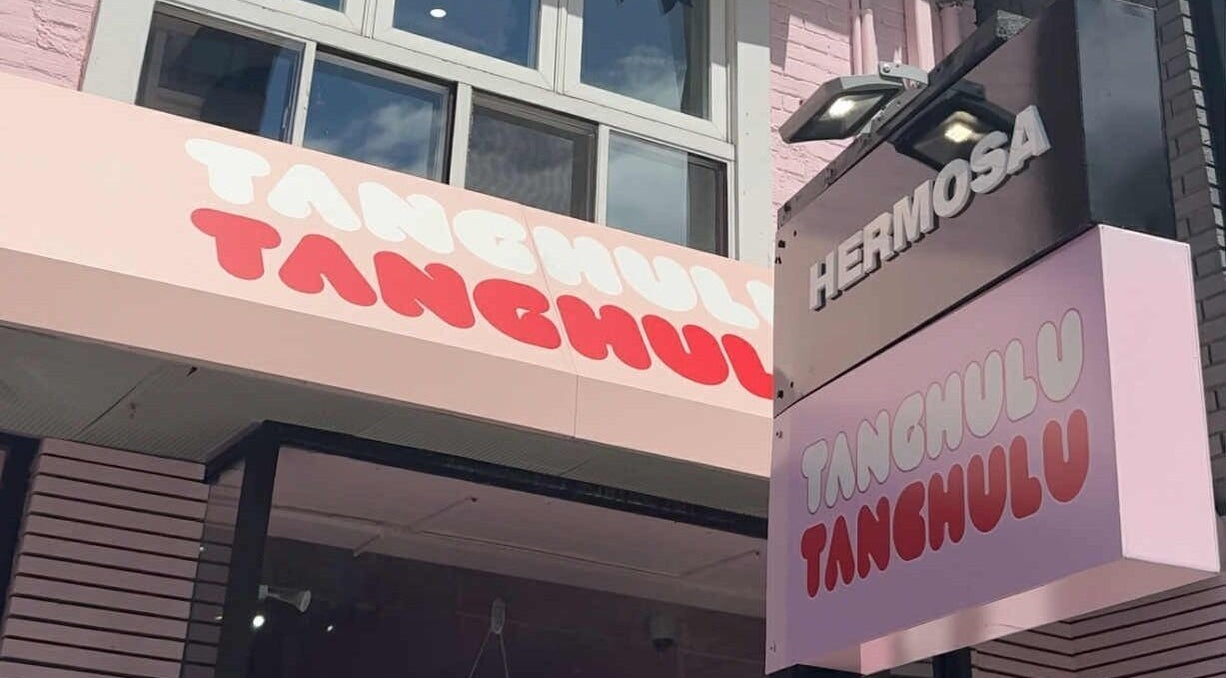 Colorful storefront showcases Tanghulu and Hermosa signage, near Mikado Aesthetics in Toronto, Ontario, CA.