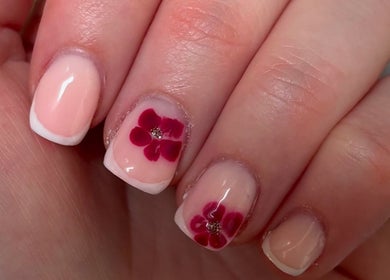 Delicate French manicure with floral design at Beauty By Eliza Grace in Broseley, England, GB.