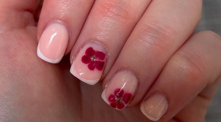 Delicate French manicure with floral design at Beauty By Eliza Grace in Broseley, England, GB.