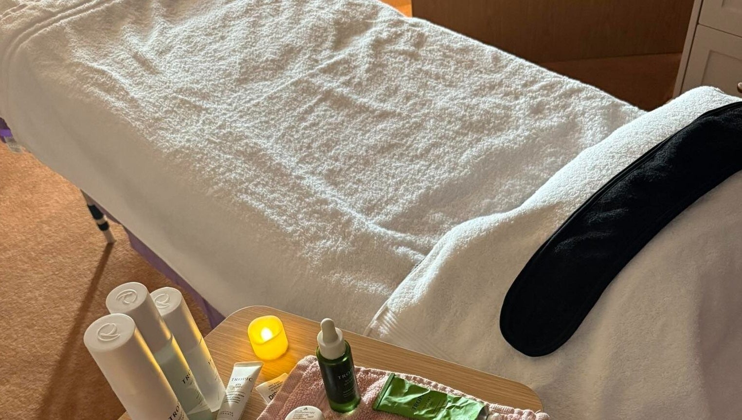 Spa table with products at Relax & Glow, Swindon, England, GB, ready for a rejuvenating treatment.