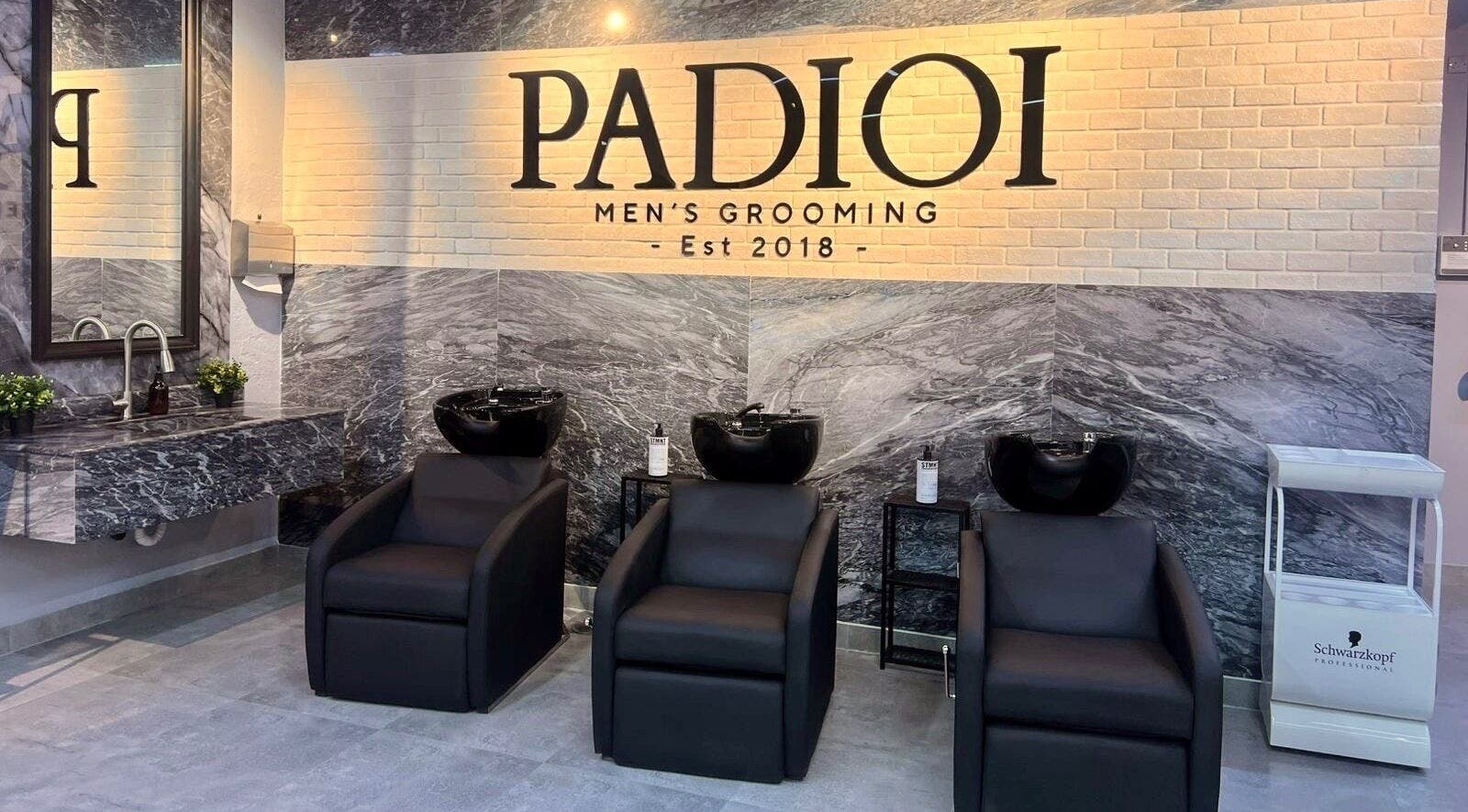 Stylish interior of Padioi Men's Grooming in Al-Khobar, SA, featuring luxury salon chairs and decor.
