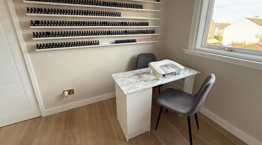 Nail station at Kirsty Allen Beauty in Prestonpans, Scotland, GB with polish display and window view.