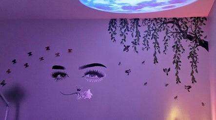 Artistic wall mural at Glowing Beauty in Christchurch, Canterbury, NZ, featuring eyes and nature elements.