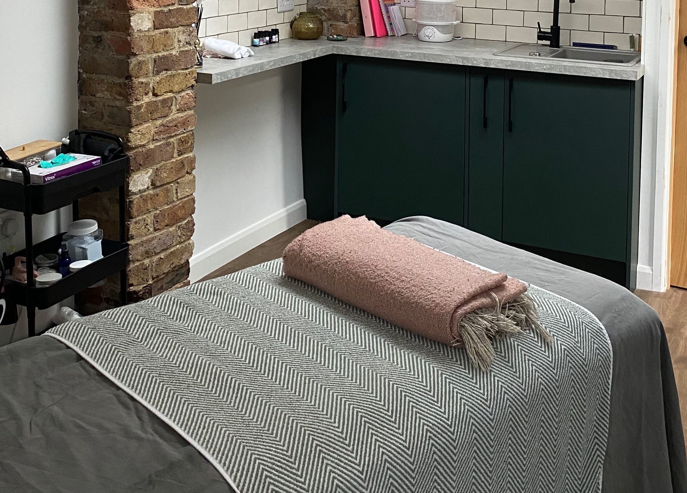 Cozy therapy room at Retreat Yourself Studio, Braintree, England, GB, featuring a relaxing massage table.