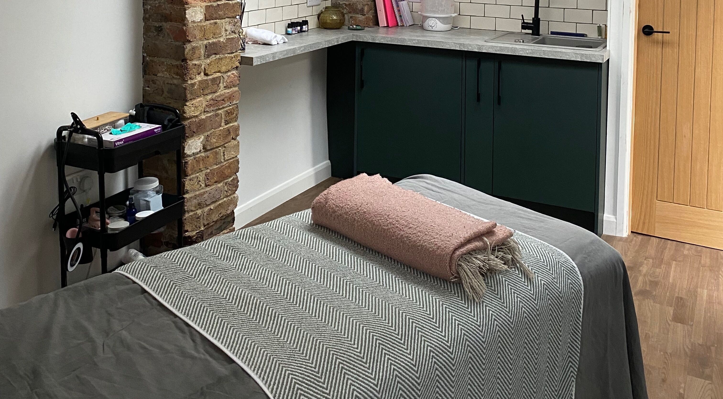Cozy therapy room at Retreat Yourself Studio, Braintree, England, GB, featuring a relaxing massage table.