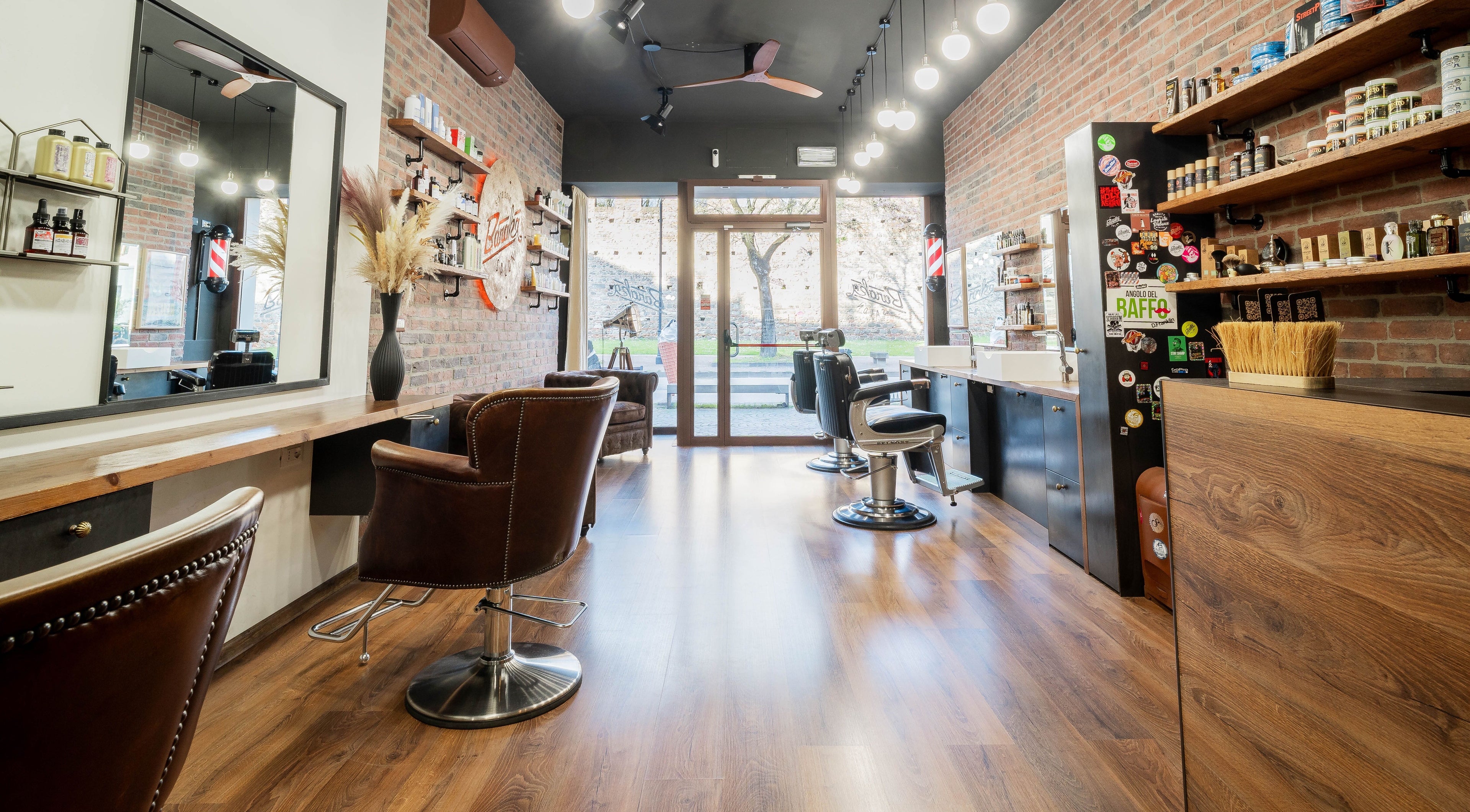 Interno raffinato di Baraka Salon, Este, Veneto, IT, con arredi moderni e pareti in mattoni.