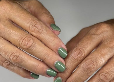 Close-up of manicured hands with green polish at NuNails Cape Town, Western Cape, ZA.