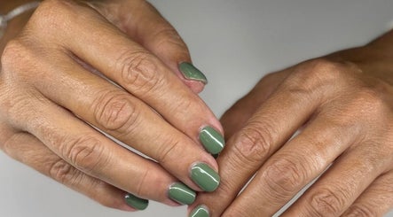 Close-up of manicured hands with green polish at NuNails Cape Town, Western Cape, ZA.