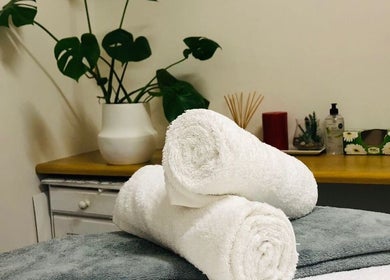 Cozy spa setup at Jessie Beauty Room, Cape Town, Western Cape, ZA with towels, plant, and decor for relaxation.