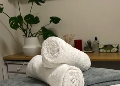 Relaxing spa setting at Jessie Beauty Room, Cape Town, Western Cape, ZA, with rolled towels and calming decor.