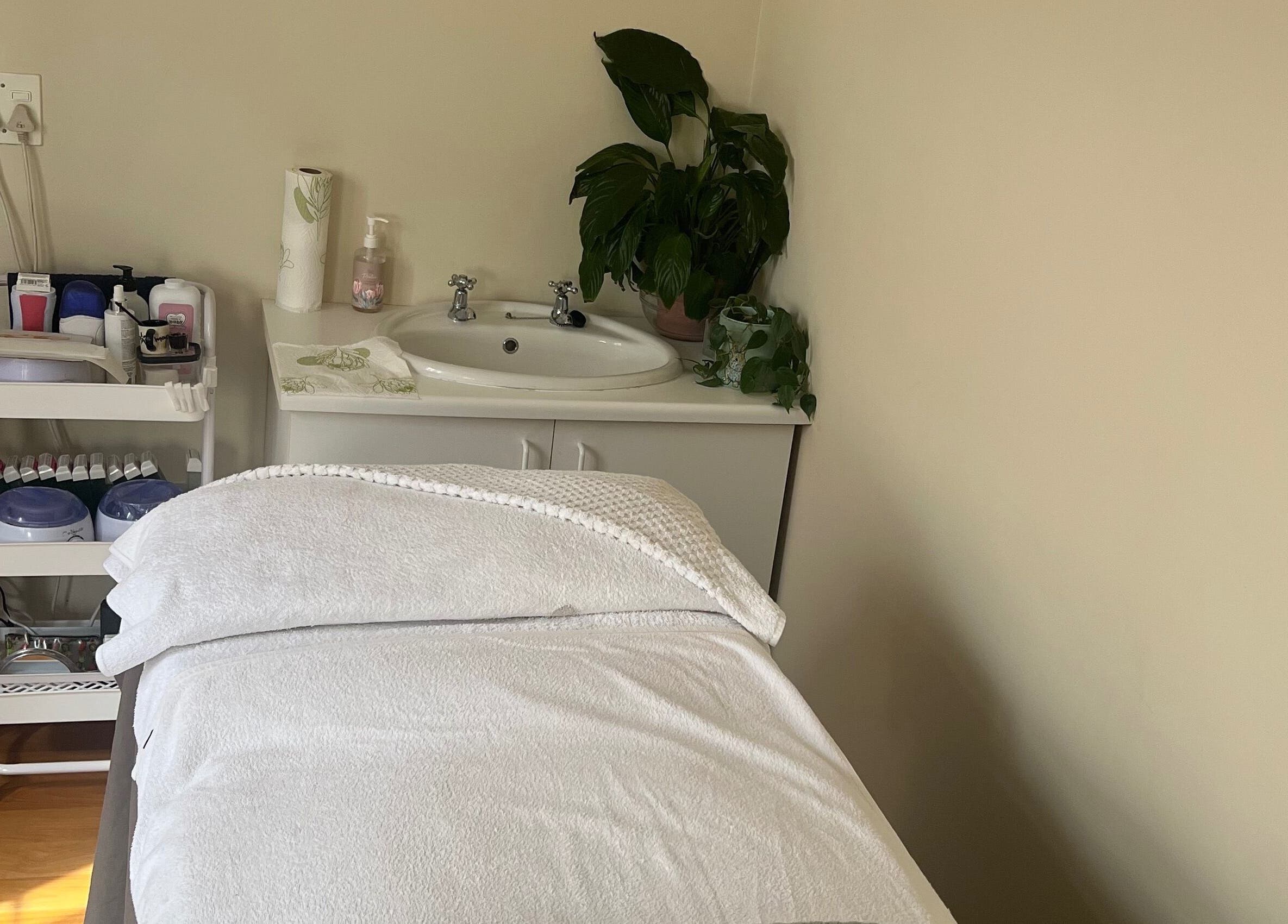 Relaxing treatment room at Jessie Beauty in Cape Town, Western Cape, ZA with a massage table and calming decor.