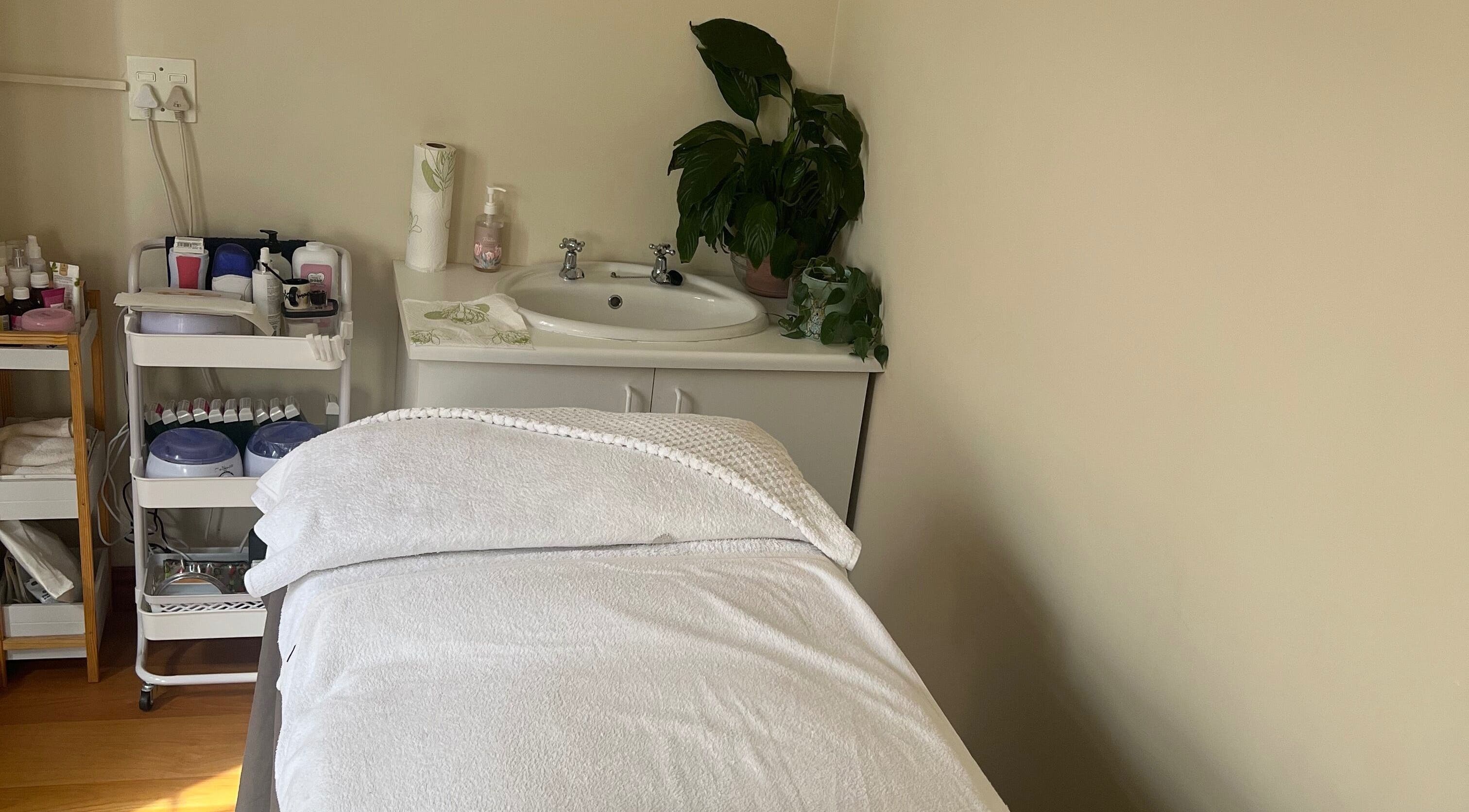 Relaxing treatment room at Jessie Beauty in Cape Town, Western Cape, ZA with a massage table and calming decor.