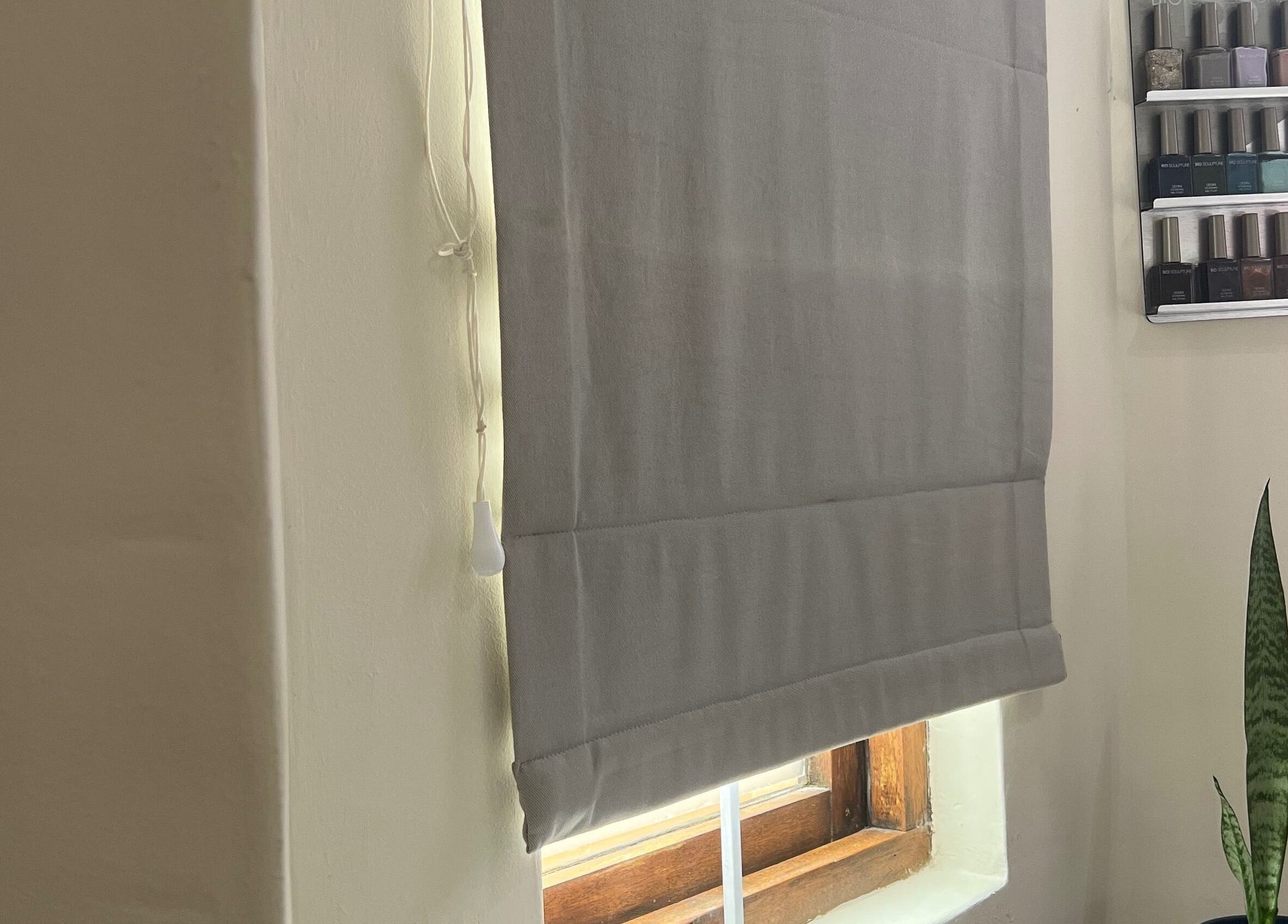 Jessie Beauty nail polish display next to window with blinds in Cape Town, Western Cape, ZA.