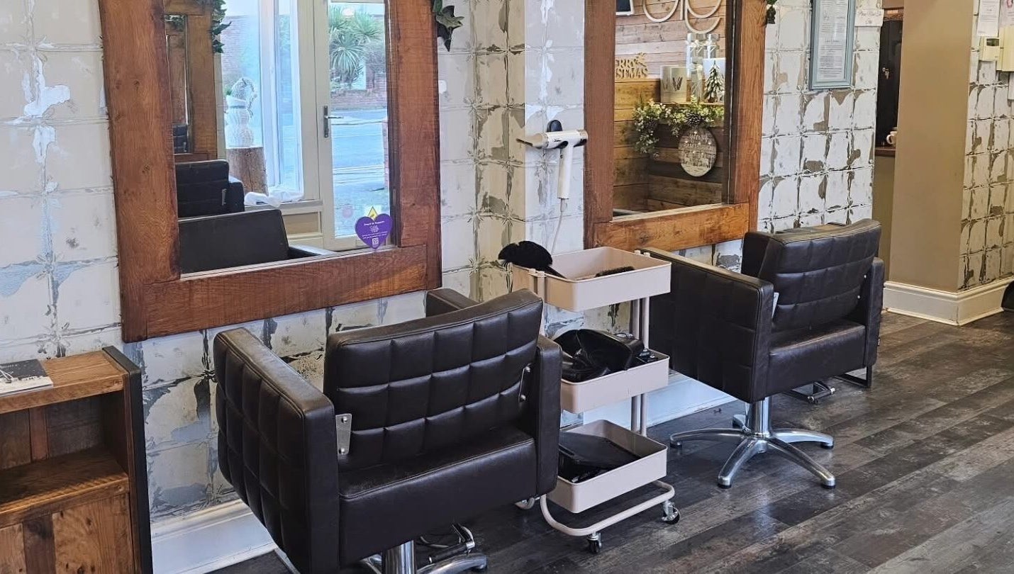 Elegant salon interior at Created By Con, featuring stylish mirrors and chairs in Blackpool, England, GB.