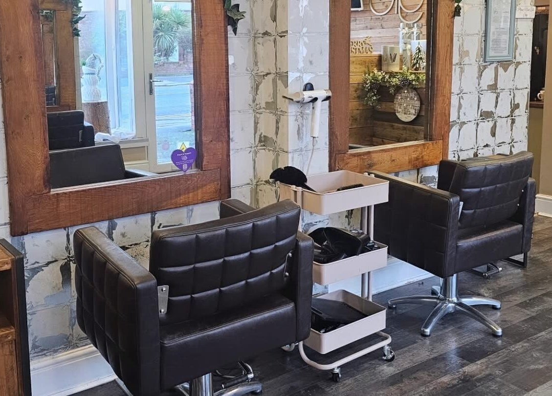 Elegant salon interior at Created By Con, featuring stylish mirrors and chairs in Blackpool, England, GB.