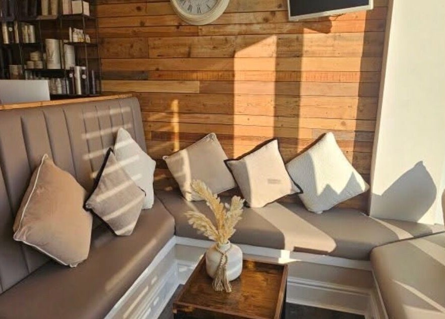 Cozy seating area with neutral decor at Created By Con in Blackpool, England, GB, featuring elegant cushions.