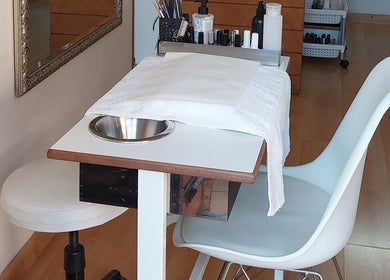 Nail station at TWO'S COMPANY Hair & Beauty in Sandton, Gauteng, ZA, featuring tools for manicures.