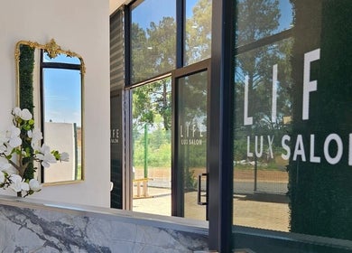 Entrance of Life Lux Salon in Centurion, Gauteng, ZA with stylish decor and mirror reflection.