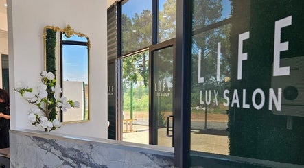Entrance of Life Lux Salon in Centurion, Gauteng, ZA with stylish decor and mirror reflection.
