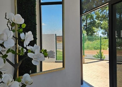Elegant entrance at Life Lux Salon, Centurion, Gauteng, ZA with flowers and greenery.