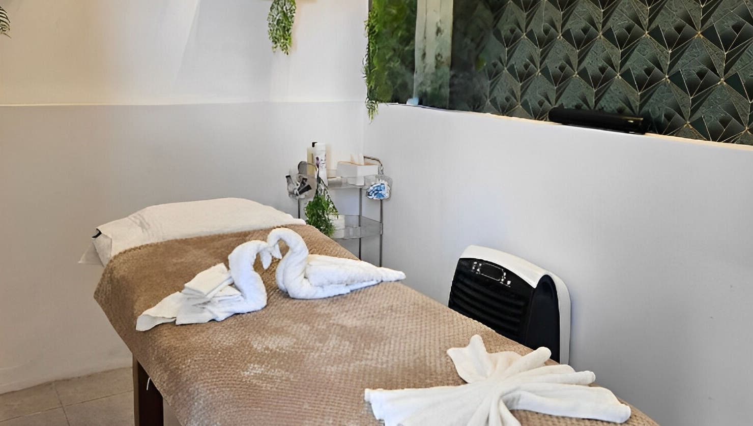 Luxurious treatment room at Life Lux Salon, Centurion, Gauteng, ZA with elegant decor and swan towels.