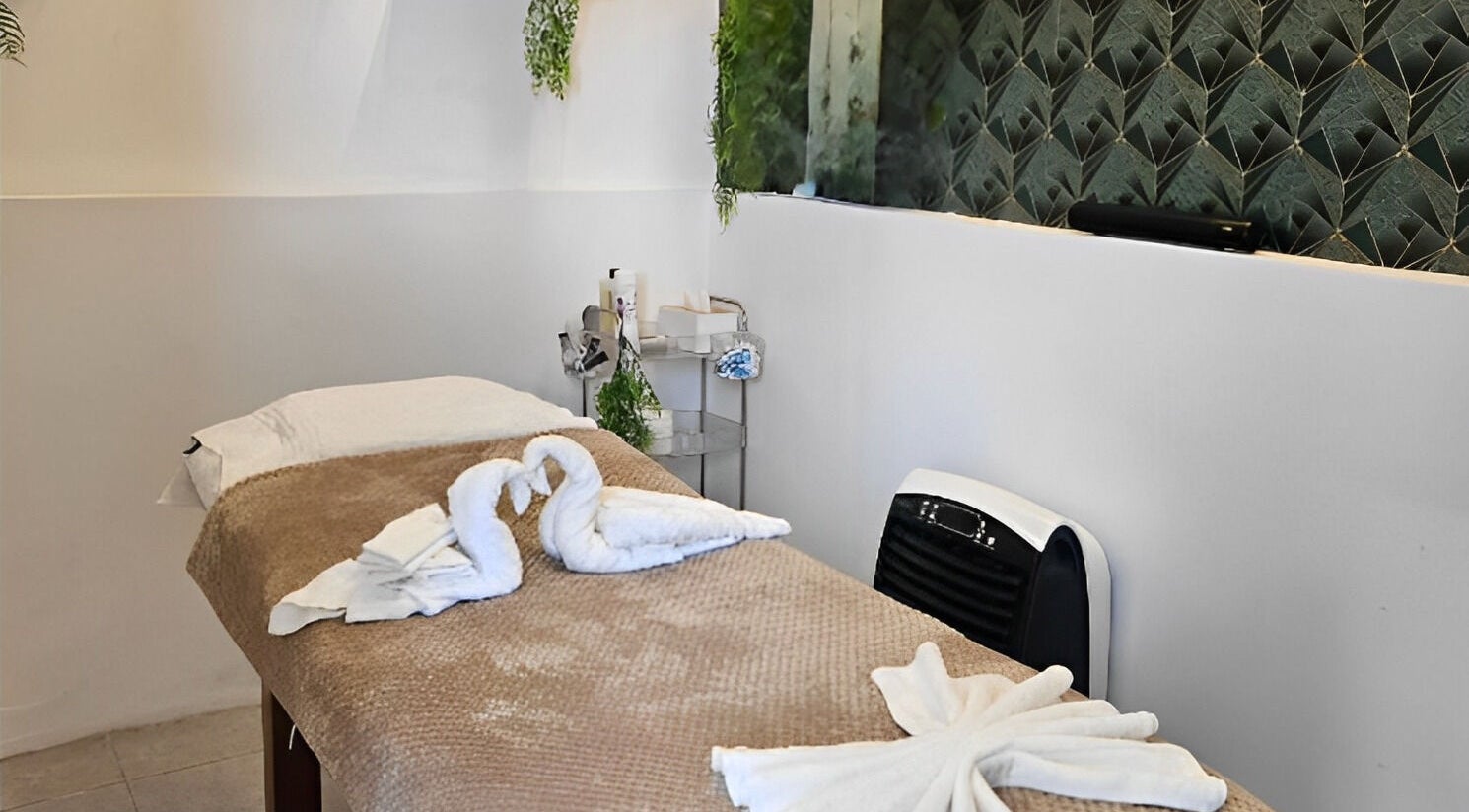 Luxurious treatment room at Life Lux Salon, Centurion, Gauteng, ZA with elegant decor and swan towels.
