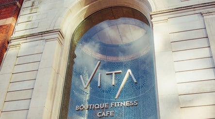 Entrance of VITA Glow Hair Salon & Head Spa, London, England, GB with stylish glass design.
