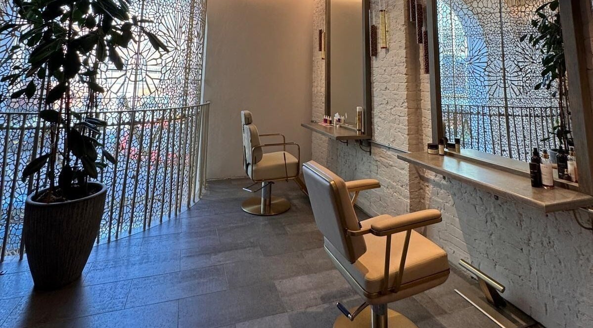 Elegant styling area at VITA Glow Hair Salon & Head Spa in London, England, GB featuring modern chairs and decor.