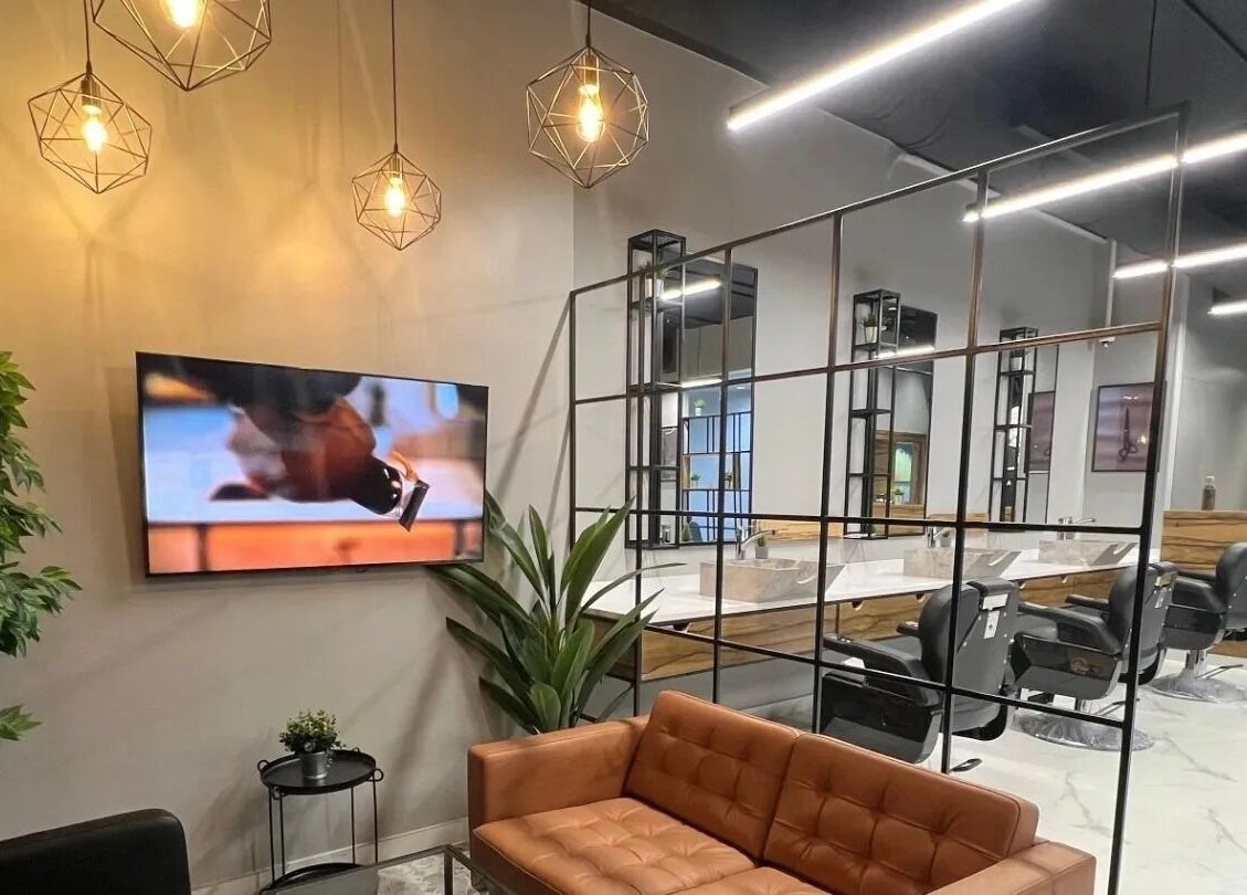 Stylish interior of Yousef Afandi-Shiekh Zayed in Giza Governorate, featuring modern seating and vibrant lighting.